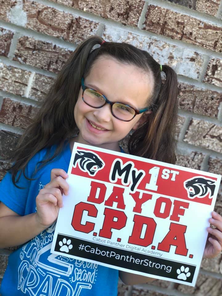 Student holding CPDA sign